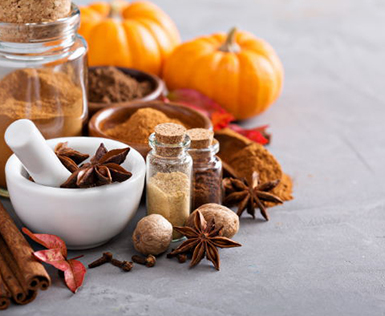 Pumpkins and spices with a grinder